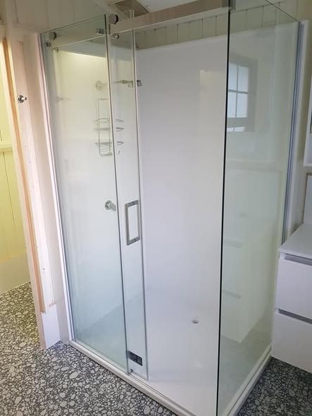 Finished glass shower tiled over completed waterproofing